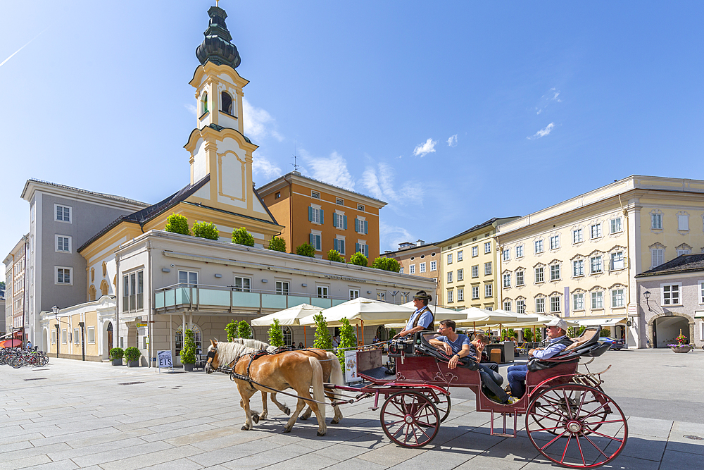 View of St. Michaelskirche and restaurants in Residenzplatz, Salzburg, Austria, Europe