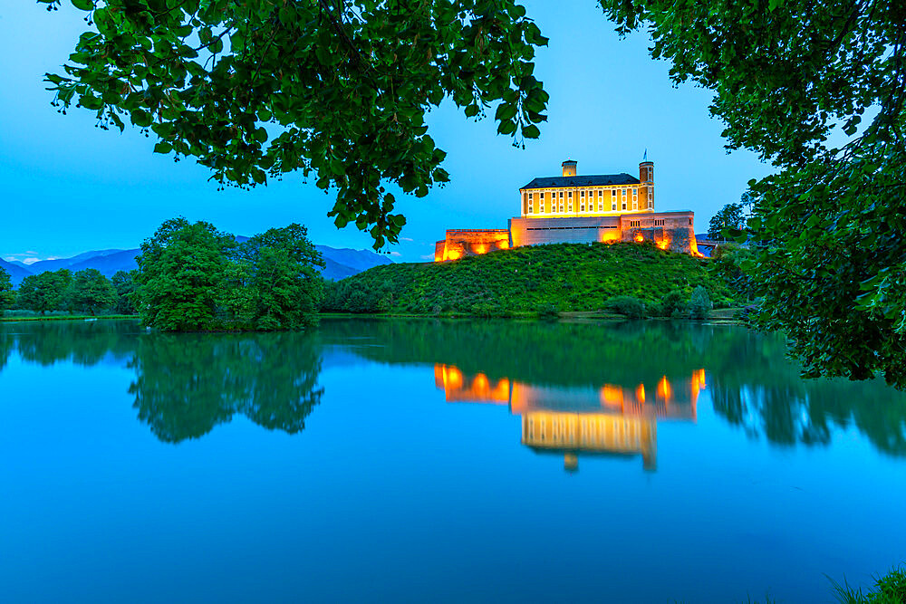 View of Trautenfels Castle reflected in nearby lake at dusk, Styria, Austria, Europe