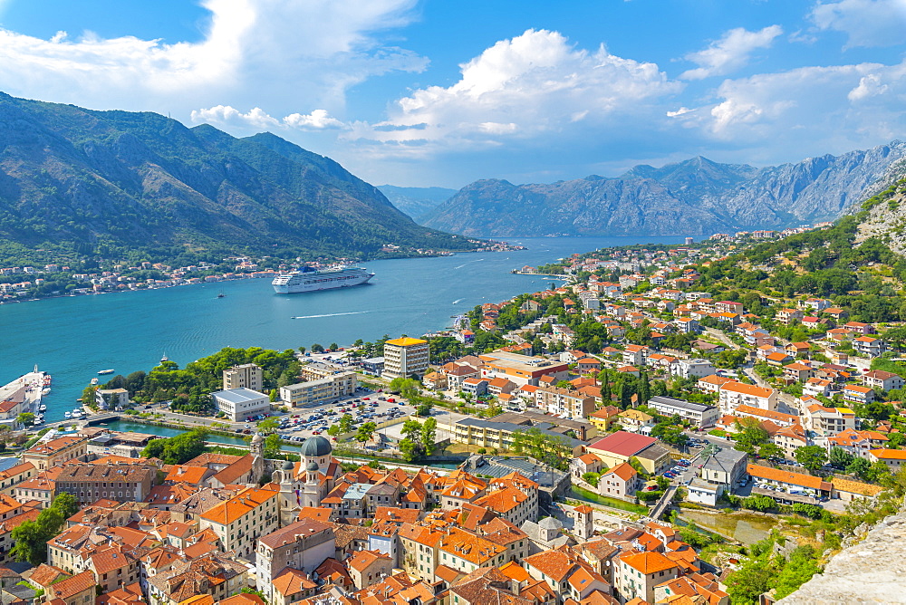 View of cruise ship and red rooftops of the Old Town, UNESCO World Heritage Site, Kotor, Montenegro, Europe