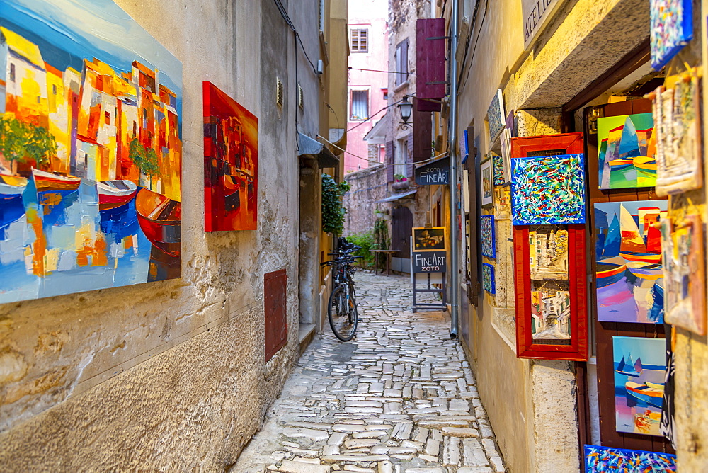 View of fine art and colourful paintings on cobbled street in the old town, Rovinj, Istria, Croatia, Adriatic, Europe