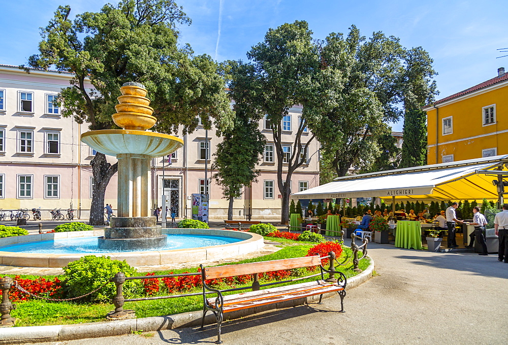 View of cafes and water fountain in Dante Square, Pula, Istria County, Croatia, Adriatic, Europe