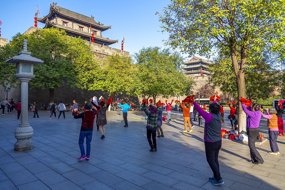 Locals performing Tai chi near City wall of Xi'an, Shaanxi Province, People's Republic of China, Asia