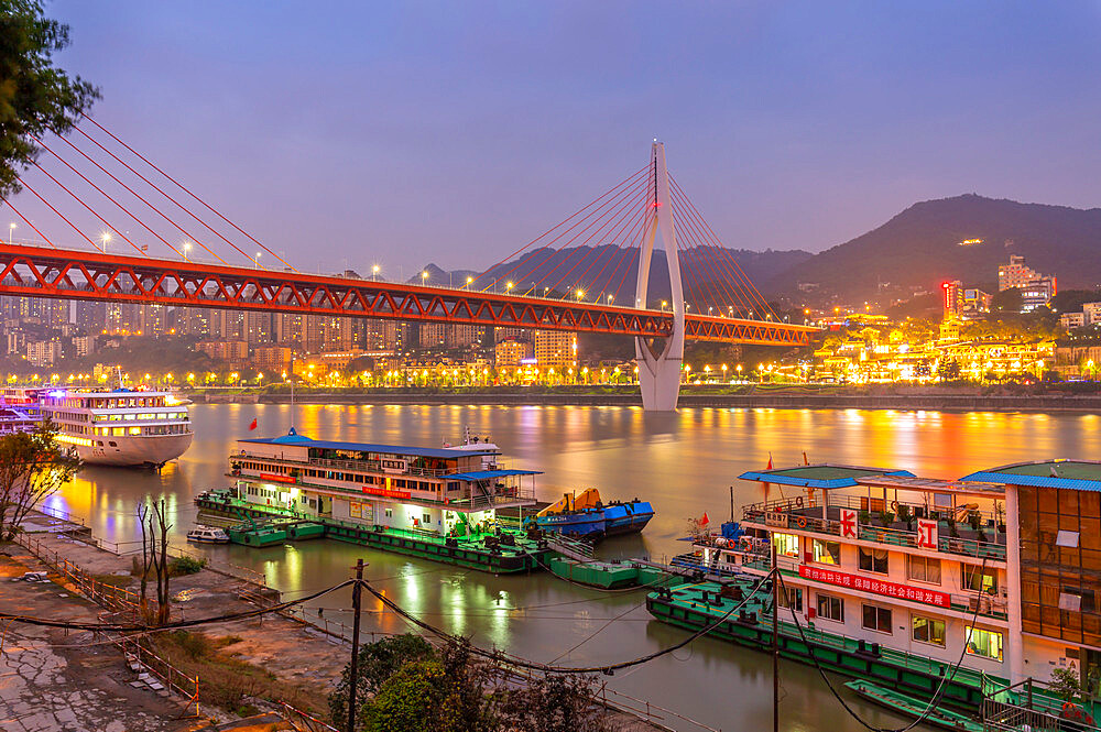 View of Masangxi Bridge and Yangtze River cruise boats at dusk, Yuzhong District, Chongqing, China, Asia