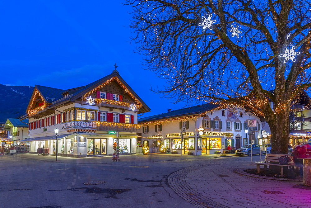 View of local shops in town at dusk, Garmisch-Partenkirchen, Bavaria, Germany, Europe