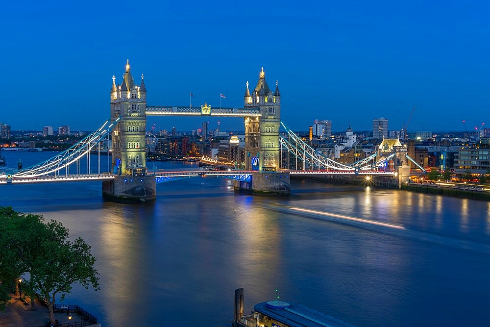 View of Tower Bridge and River Thames from Cheval Three Quays at dusk, London, England, United Kingdom, Europe