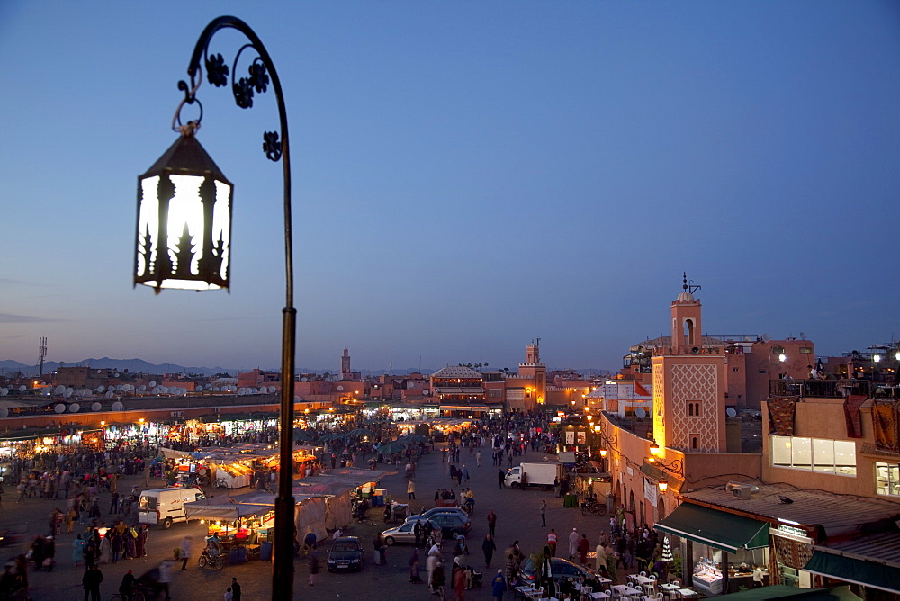 View over market square at dusk, Place Jemaa El Fna, Marrakesh, Morocco, North Africa, Africa