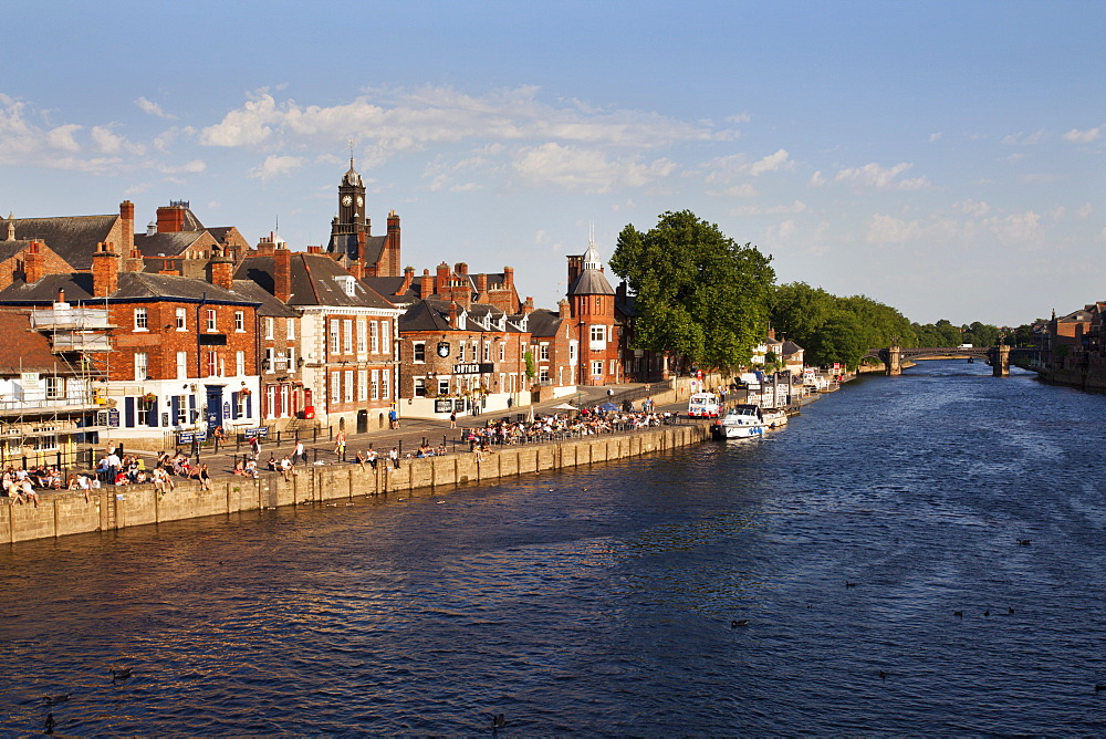 People sitting along Kings Staith by the River Ouse on a summer evening, City of York, Yorkshire, England, United Kingdom, Europe 