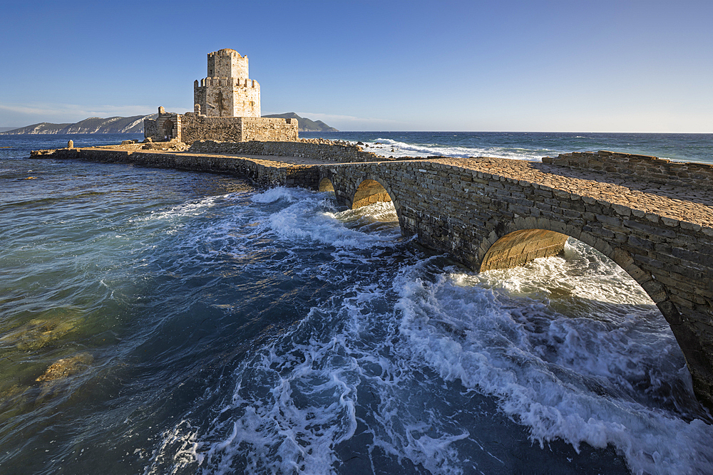 Bourtzi octagonal tower of Methoni Castle and the stone bridge in stormy sea, Methoni, Messenia, Peloponnese, Greece, Europe