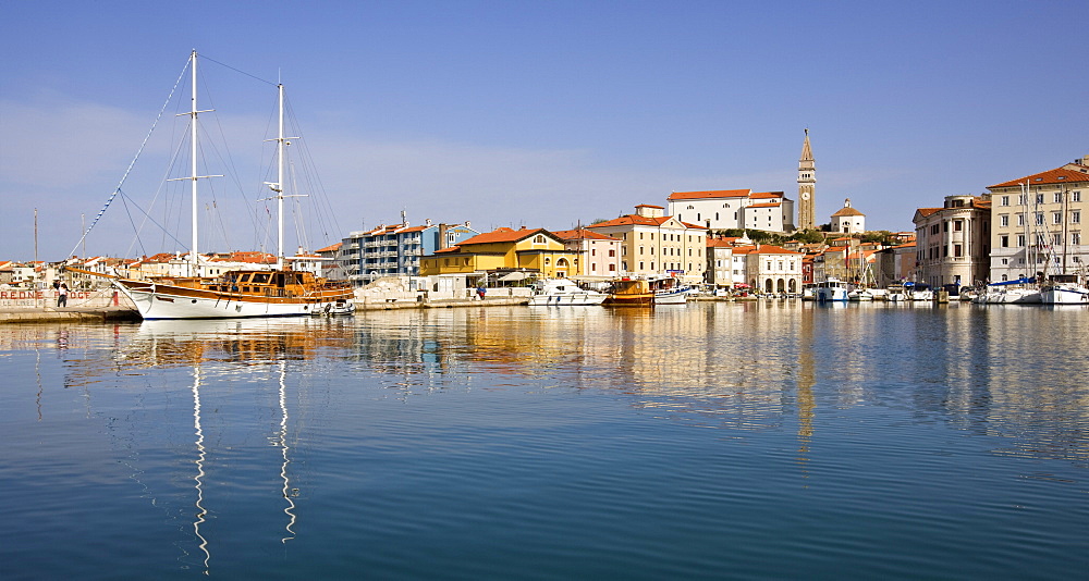 Looking over Piran Harbour towards Tartini Square and the Church of St. George, Piran, Slovenia, Europe