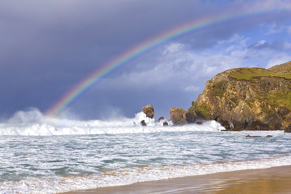 Sea stacks, rainbow, stormy clouds and rough seas on a windy afternoon at Dalmore Bay on the Isle of Lewis, Outer Hebrides, Scotland, United Kingdom, Europe