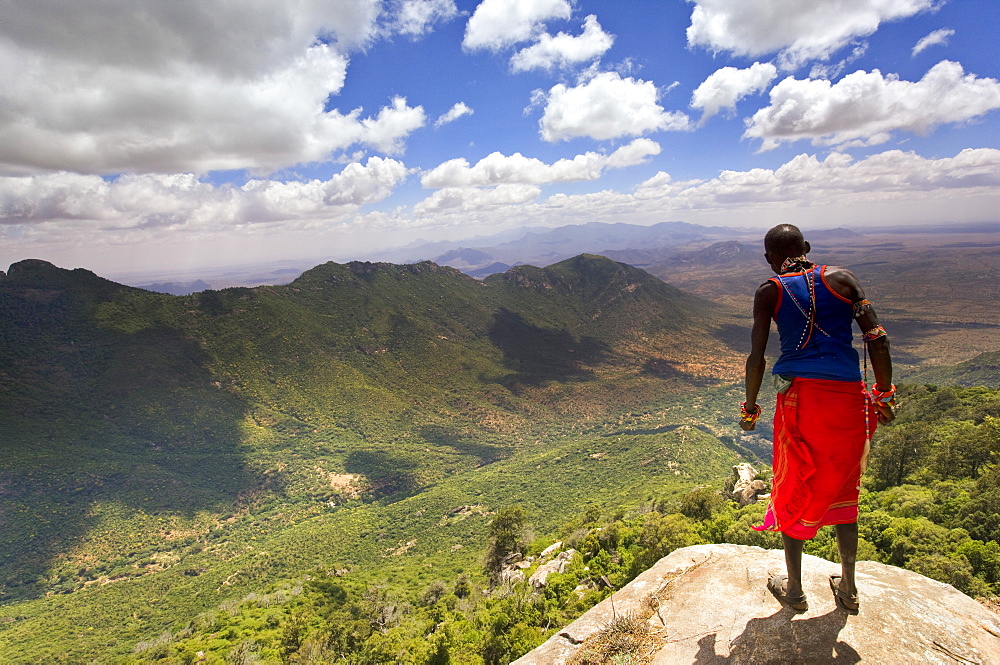 Samburu man looks down over the Ewaso Rongai Valley from Mount Nyiru, Northern Frontier, Kenya, East Africa, Africa