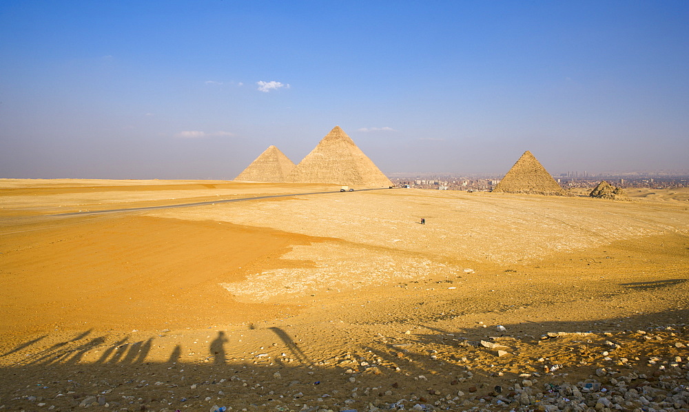 Late shadows of tourists at the viewpoint overlooking the Pyramids of Giza, UNESCO World Heritage Site, with Cairo in the background, Egypt, North Africa, Africa