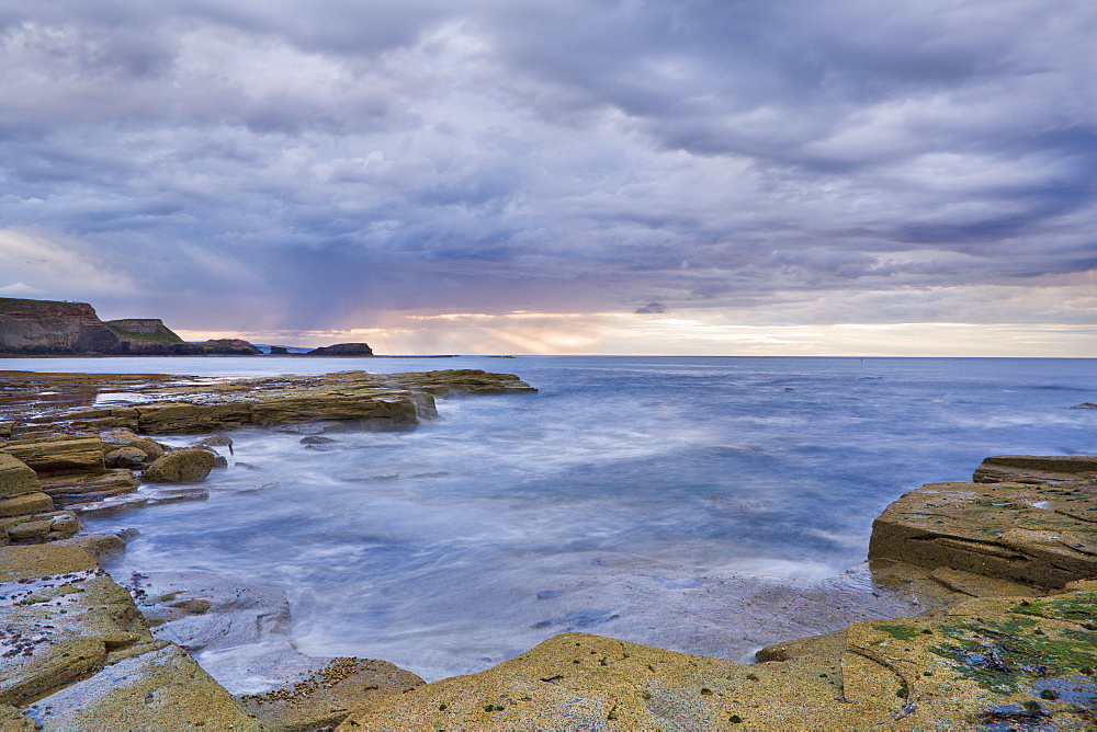 A showery evening at low tide in Saltwick Bay, North Yorkshire, Yorkshire, England, United Kingdom, Europe