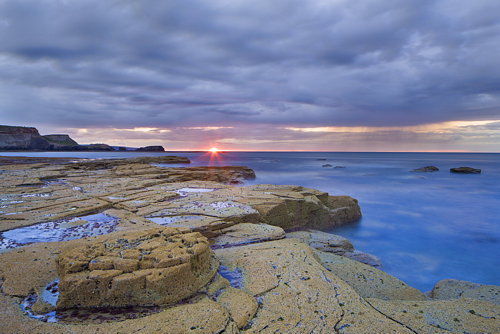 Sunset on a showery evening at Saltwick Bay, North Yorkshire, Yorkshire, England, United Kingdom, Europe