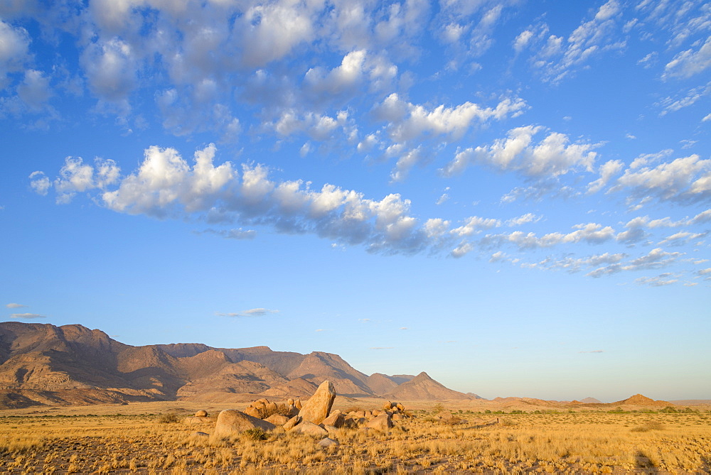 Boulders on the plains below the Brandberg mountain range at sunrise, Damaraland, Namibia, Africa