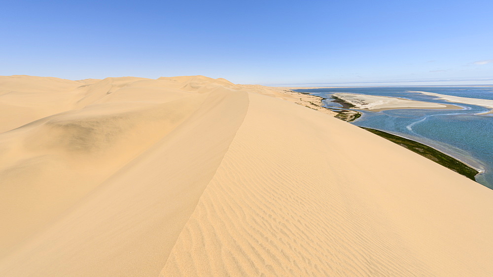 The dunes and lagoon of Sandwich Harbour, just south of Walvis Bay and within the Namib Naukluft Park, Namibia, Africa