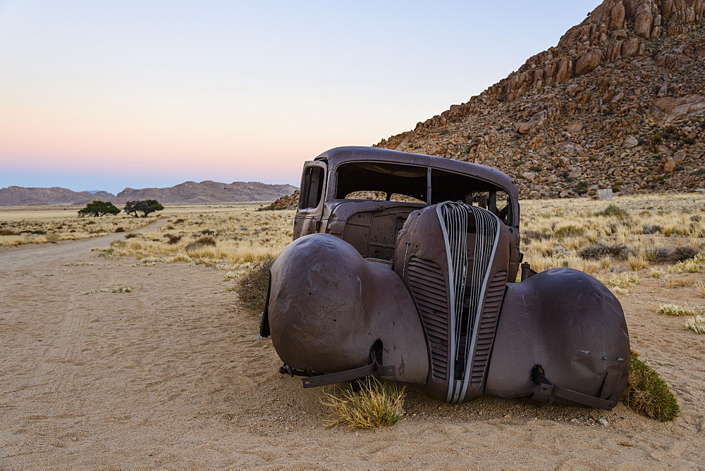 Burnt out remains of an old Hudson car, said to have been used by diamond thieves, in the Gondwana Sperrgebiet Rand Park, Namibia, Africa