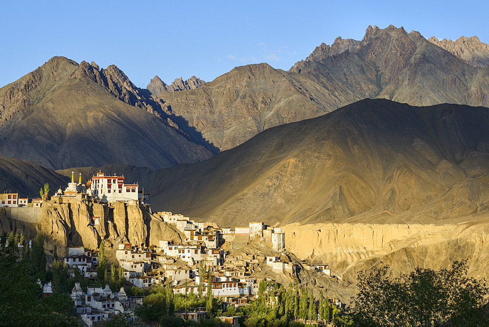 The town and monastery of Lamayuru, backed by mountains in the evening sun, Ladakh, Himalayas, India, Asia