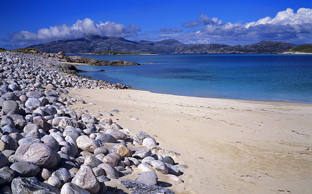 Sand and boulder beach on the island of Scarp just off the Isle of Harris on a late afternoon in June, Outer Hebrides, Scotland, United Kingdom, Europe