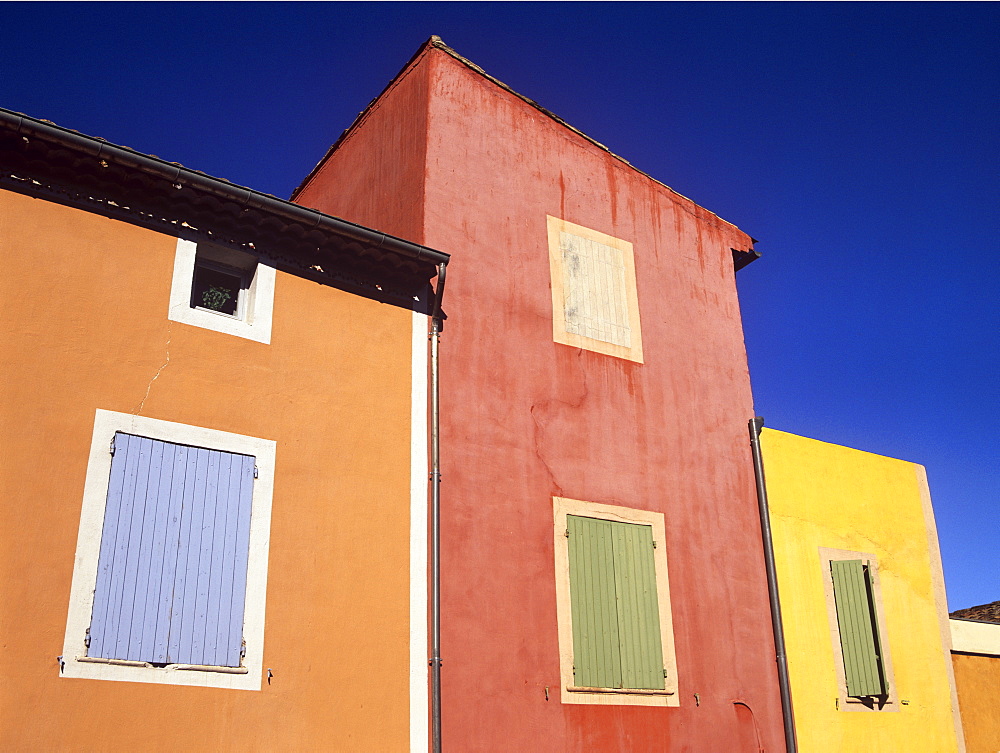 Ochre tinted houses in the colourful village of Roussillon, Provence, France, Europe