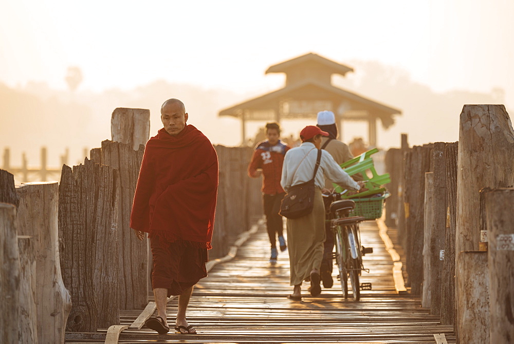 Early morning pedestrian traffic on U-Bein Bridge, Amarapura, Mandalay, Mandalay Region, Myanmar (Burma), Asia