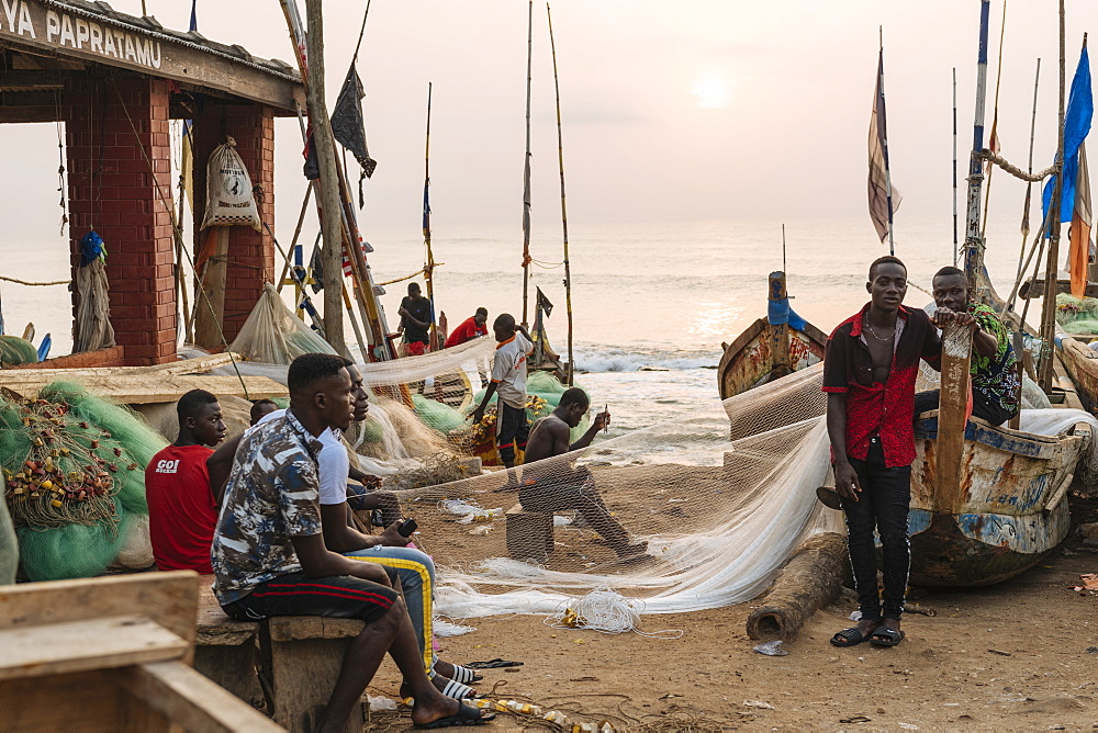 Fishermen fixing nets in Cape Coast, Ghana, Africa