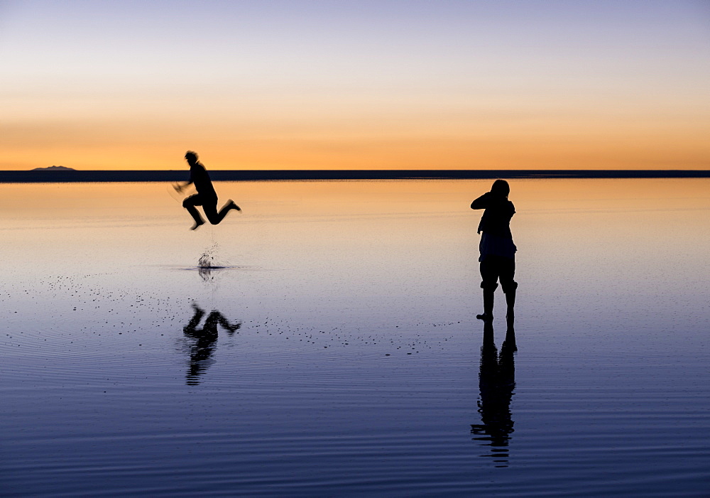 Tourists enjoying the Sunset over the Salar de Uyuni, Southern Altiplano, Bolivia, South America