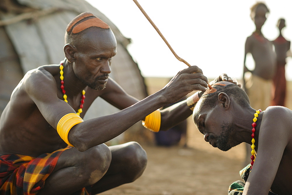 Shuoloch applying clay hair decoration to Chafich, Dassanech Tribe, Salany Village, Omorate, Omo Valley, Ethiopia, Africa