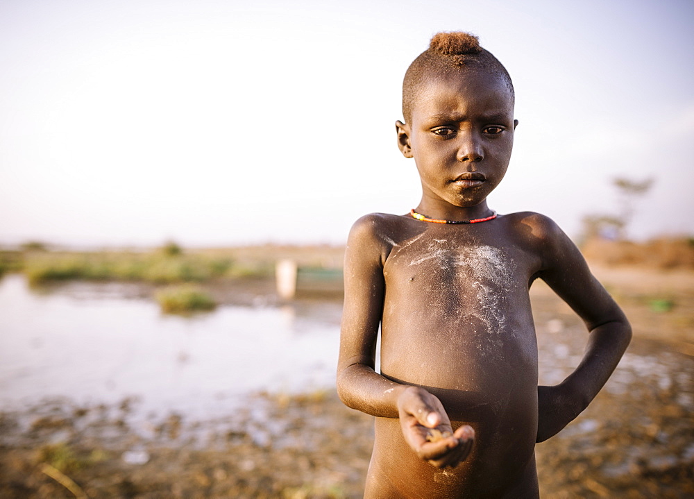 Children fishing on the shore of Turkana Lake, Dassanech Tribe, Omo Valley, Ethiopia, Africa