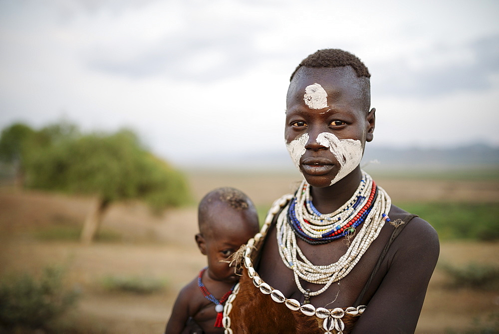 Portrait of Gabo with baby Nanega, Kara Tribe, Korcho Village, Omo Valley, Ethiopia, Africa