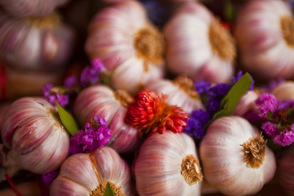 Garlic on sale at a market in soft focus Tours, Indre-et-Loire, Centre, France, Europe