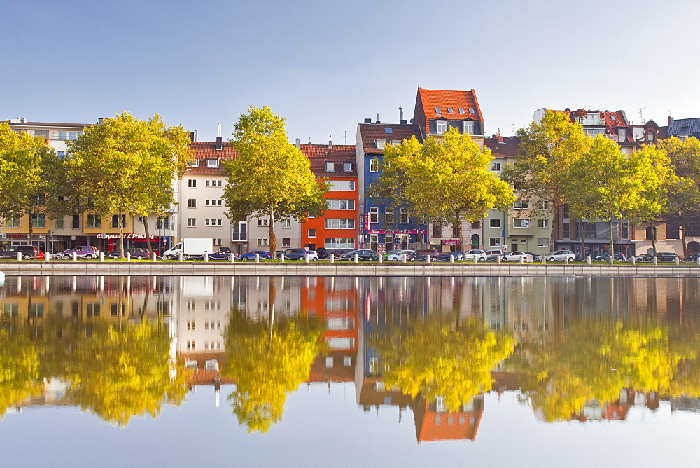 Houses and shops reflecting in a pond, Cologne, North Rhine-Westphalia, Germany, Europe 