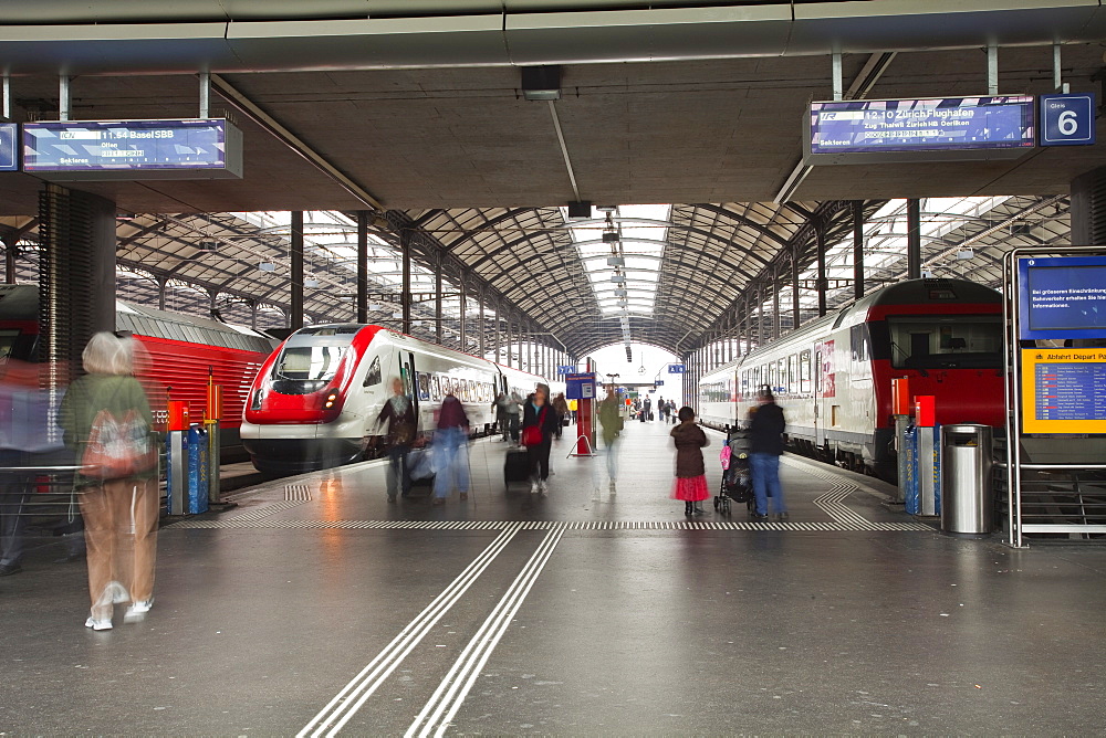 Passengers rushing through Lucerne railway station, Lucerne, Switzerland, Europe 