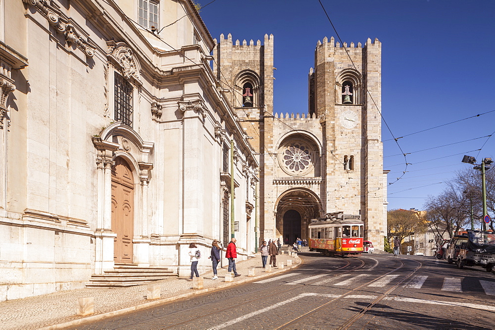 Tram 28 and Lisbon Cathedral (Se) dating from the 12th century and a mixture of architectural styles, Lisbon, Portugal, Europe