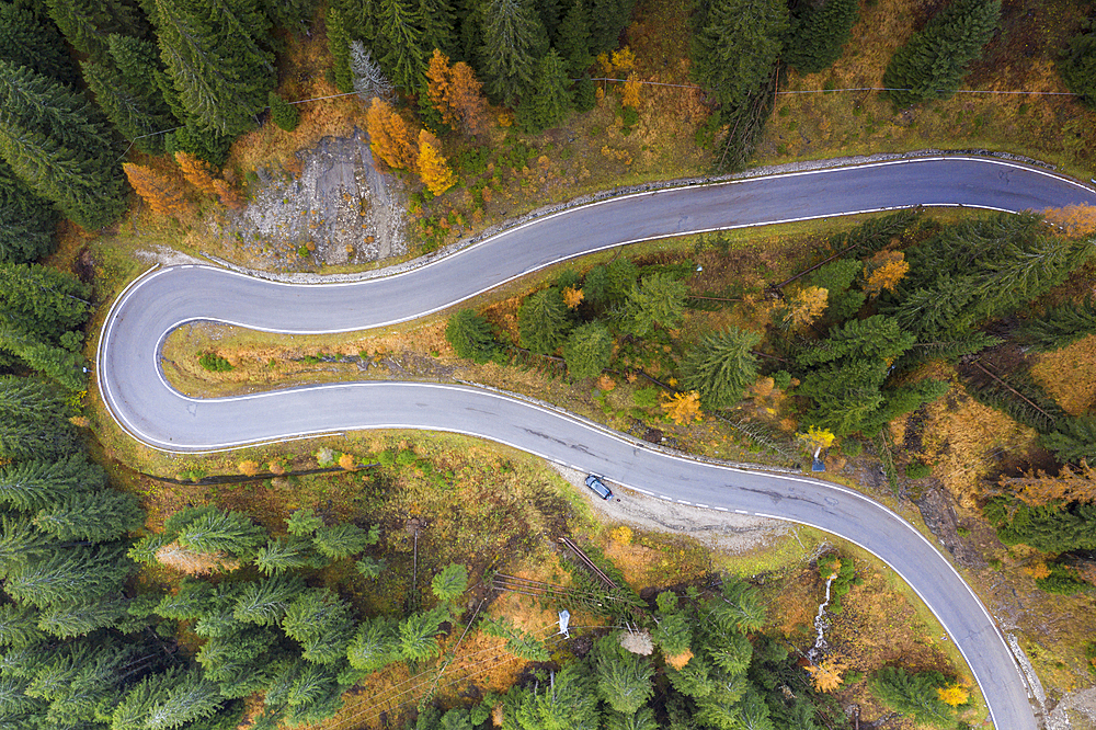 A view by drone of a winding road in the Dolomites, Veneto, Italy, Europe