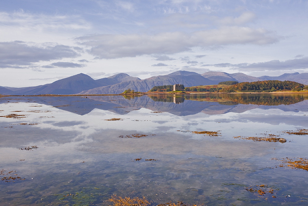 Castle Stalker reflecting into the waters of Loch Laich, Argyll and Bute, Scotland, United Kingdom, Europe 