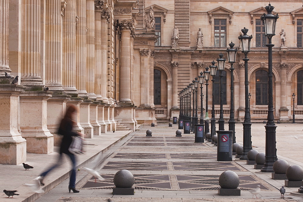 A woman walks through the Louvre Museum in Paris, France, Europe