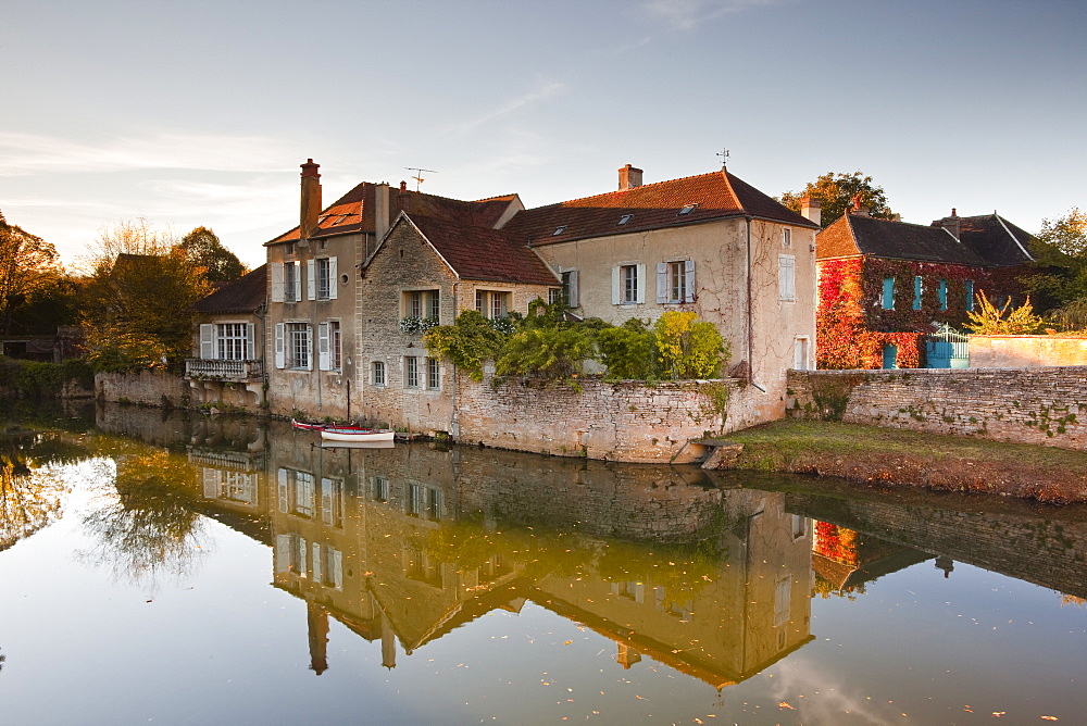 A house reflecting in the River Serein in the village of Noyers-sur-Serein, Yonne, Burgundy, France, Europe 