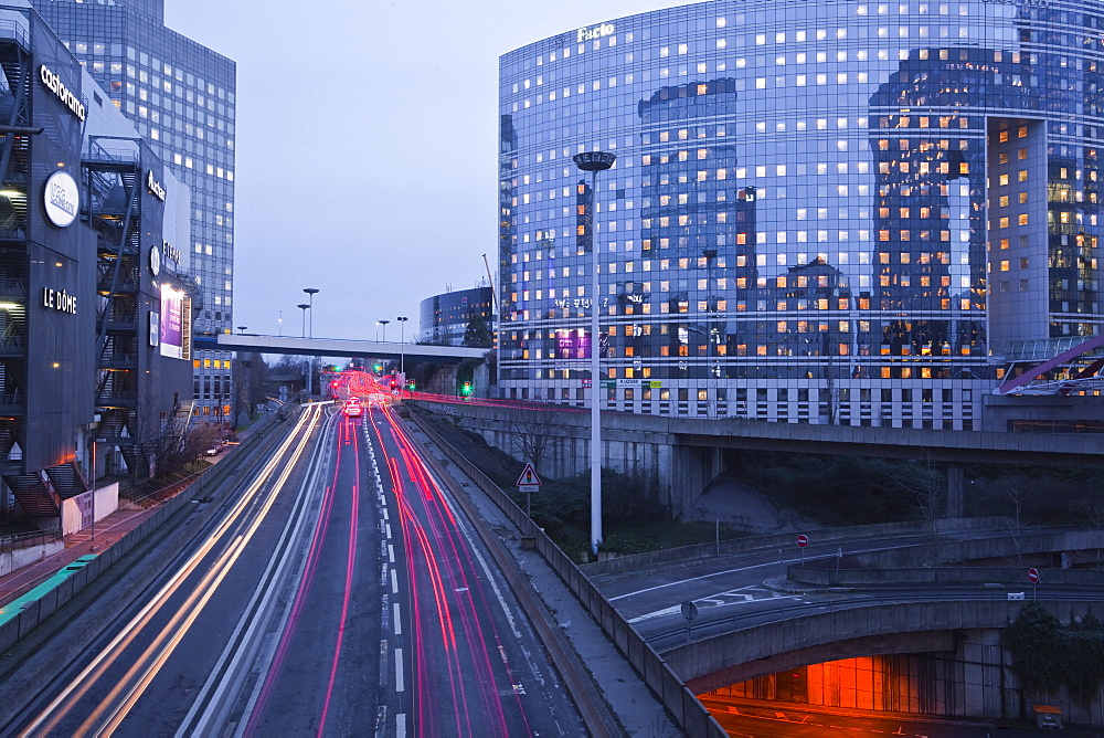 Evening traffic flowing through the La Defense area of Paris, France, Europe 