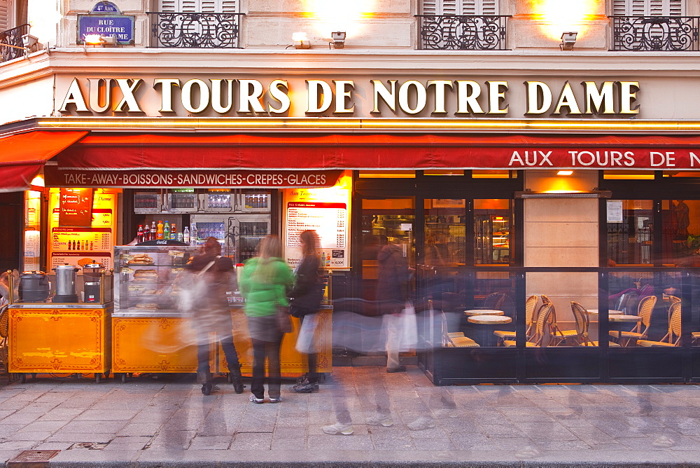 Tourists stand in line for a quick snack outside a restaurant in Paris, France, Europe