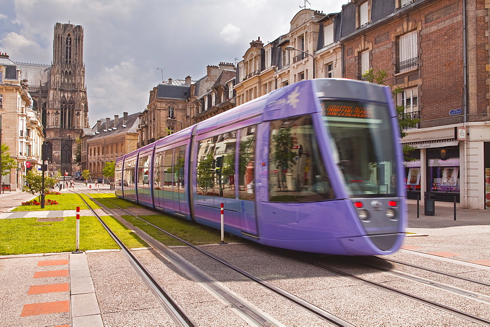 A tram passes in front of Notre Dame de Reims cathedral, Reims, Champagne-Ardenne, France, Europe