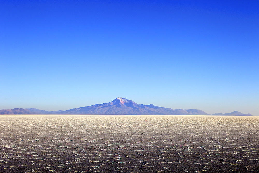 Salar de Uyuni salt flat and Mount Tunupa, Andes mountains in the distance in south-western Bolivia, South America