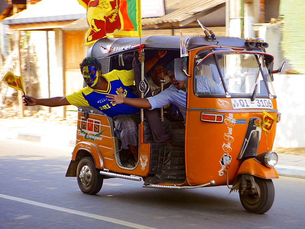 Sri Lankan cricket supporters driving along in a Tuk tuk (rickshaw) during the cricket World Cup final 2011, Sri Lanka, Asia