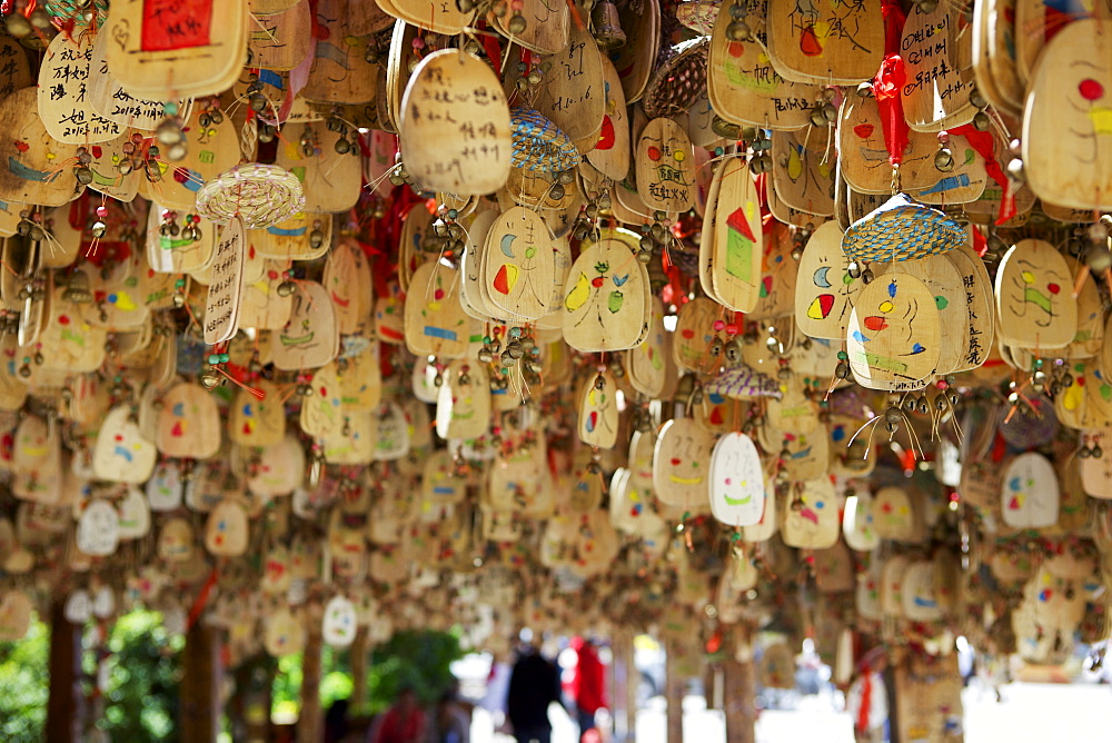 Hanging blessings of Naxi pictograms on wood in the Old Town, Lijiang, UNESCO World Heritage Site, Yunnan Province, China, Asia