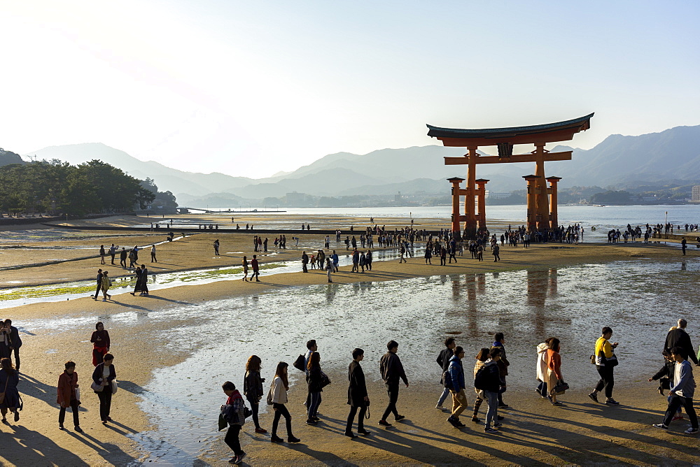 The red wooden torii gate at low tide on Miyajima island, Itsukushima, UNESCO World Heritage Site, Hiroshima Prefecture, Honshu, Japan, Asia