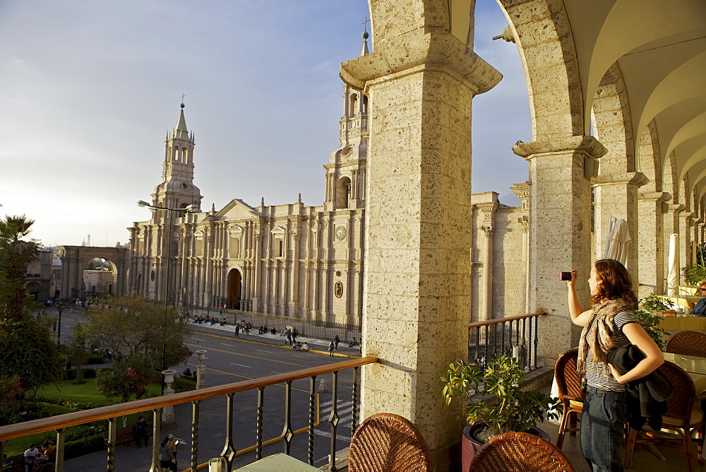 Woman taking photograph of Arequipa Cathedral (la catedral) Plaza de Armas, Arequipa, peru, peruvian, south america, south american, latin america, latin american South America