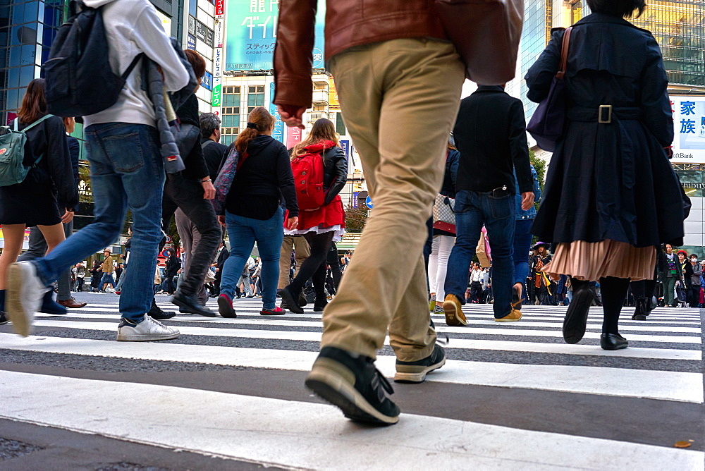 Low angle view of crowds walking through the Shibuya Crossing, Tokyo, Japan, Asia