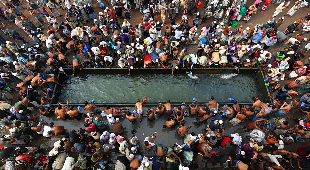 Muslims are taking bath at Bishwa Ijtema field. The â€œBishwa Ijtemaâ€ the World or Global Congregation or Meeting is an annual Tablighi Jamaat Islamic movement congregation held at Tongi, Bangladesh by the river Turag