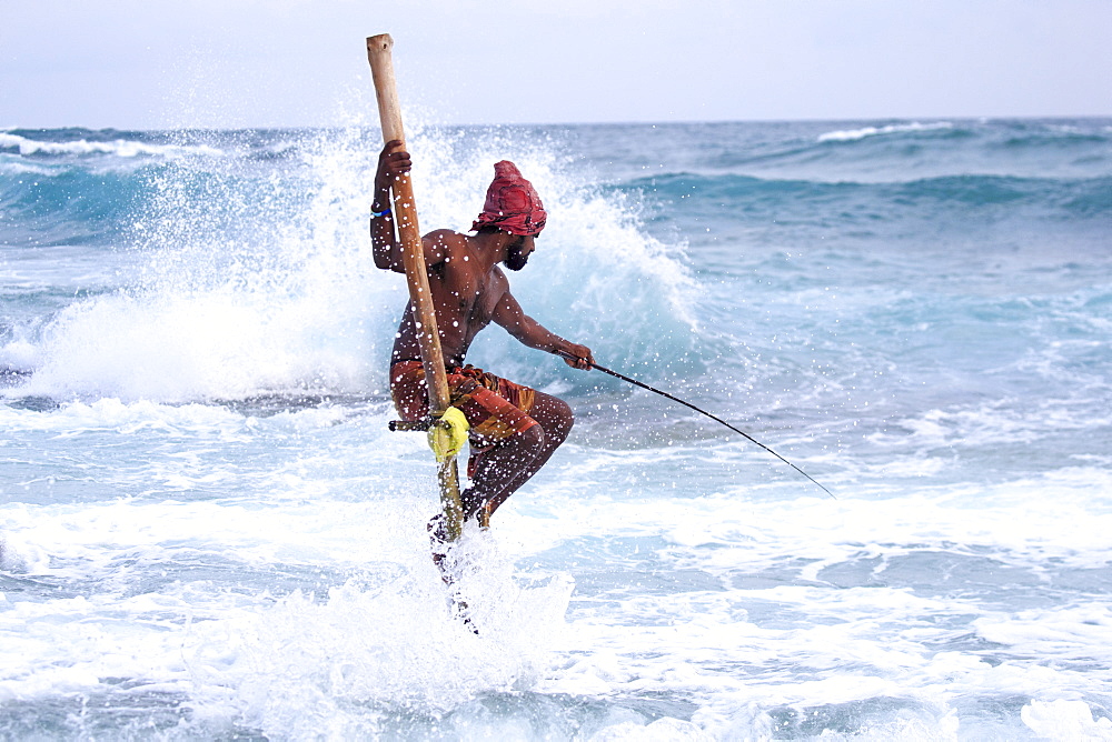 Stilt fisherman near the beach, traditional fishing, Weligama, Indian Ocean, Sri Lanka