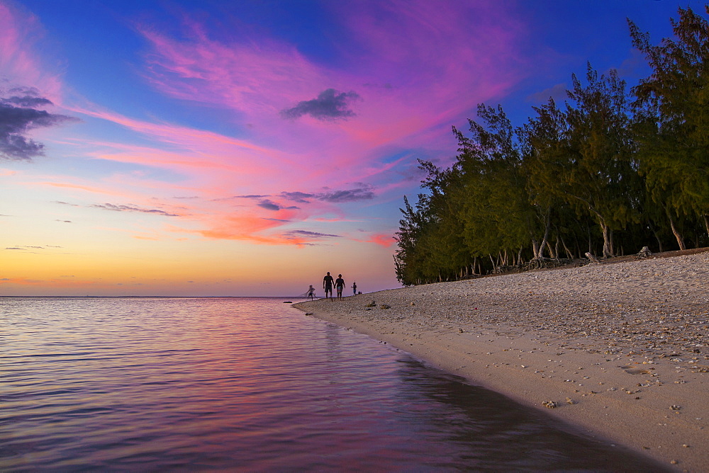 Family walk at sunset on the beach of l'Ermitage, La Reunion Marine Nature Reserve, Indian Ocean